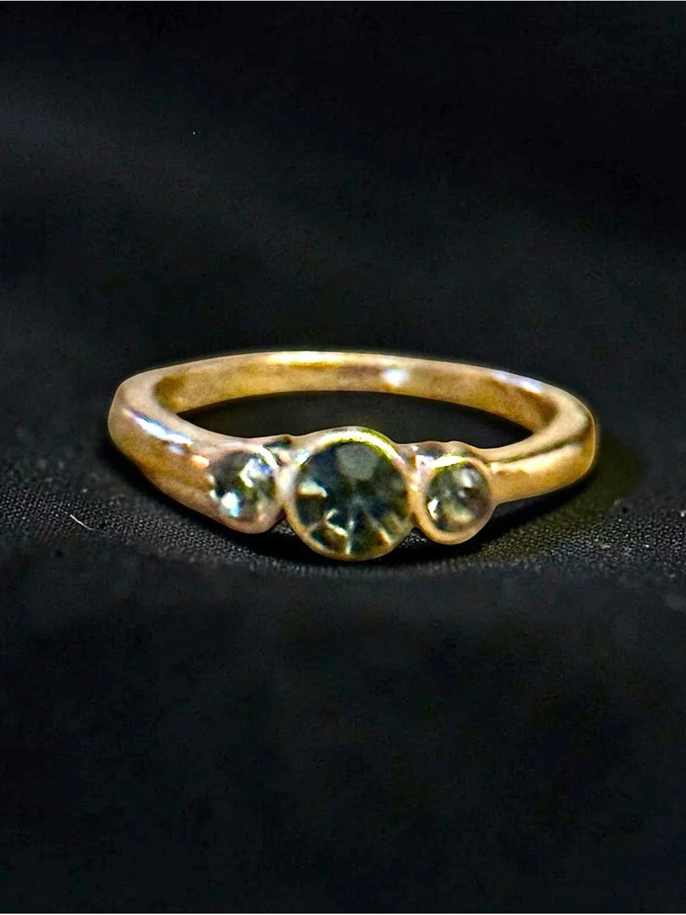 Dainty gold tone bezel set three stone ring